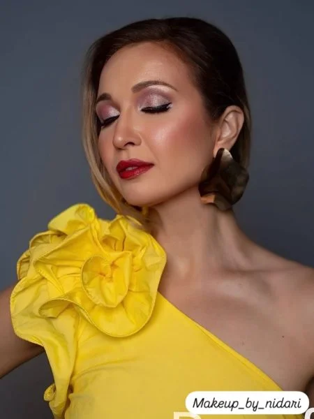 Editorial glam makeup look by Makeup by Nidari — soft shimmer eyes and bold lip
