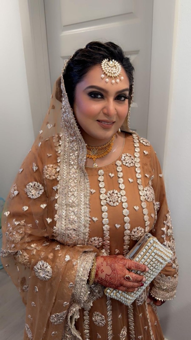 Glowing bridal makeup with embellished outfit and mehndi by Makeup by Nidari