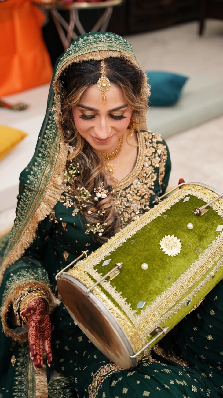 Mehndi day glam in emerald with gold jewelry and dholki by Makeup by Nidari, Houston